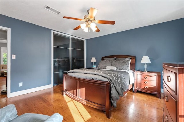 bedroom with wood-type flooring and ceiling fan