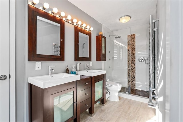 bathroom featuring walk in shower, tile patterned flooring, vanity, and toilet