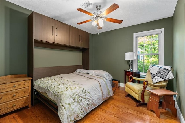 bedroom with ceiling fan and light wood-type flooring