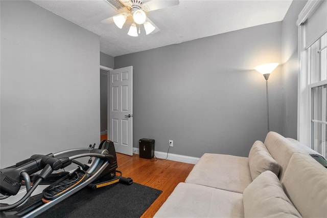 exercise area with ceiling fan and hardwood / wood-style flooring