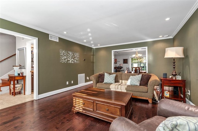 living room featuring an inviting chandelier, hardwood / wood-style flooring, and ornamental molding