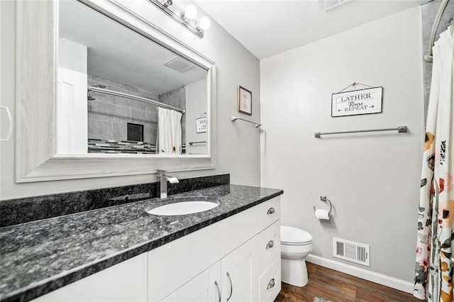 bathroom with vanity, hardwood / wood-style floors, and toilet