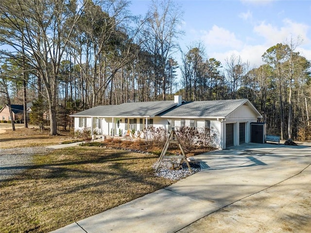 single story home with a garage, a front lawn, and a porch