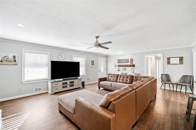 living room featuring crown molding, ceiling fan, hardwood / wood-style floors, and a textured ceiling