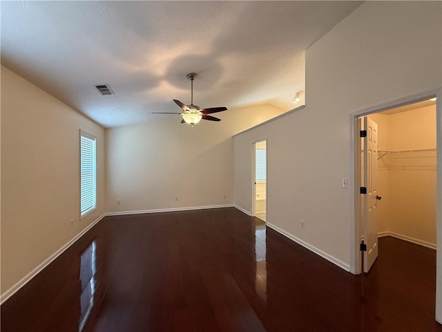 1245 Mulberry Mill Ln, Lawrenceville, GA 30043 - empty room featuring a ceiling fan, dark wood finished floors, and vaulted ceiling