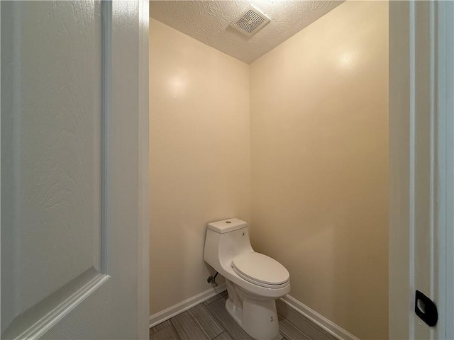 1245 Mulberry Mill Ln, Lawrenceville, GA 30043 - bathroom featuring wood finished floors and a textured ceiling