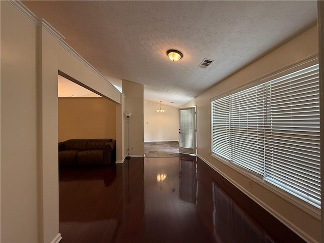 1245 Mulberry Mill Ln, Lawrenceville, GA 30043 - corridor featuring a textured ceiling, vaulted ceiling, hardwood / wood-style flooring, and a chandelier