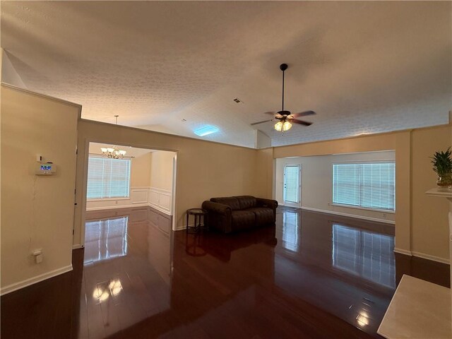 1245 Mulberry Mill Ln, Lawrenceville, GA 30043 - living area with wood finished floors, lofted ceiling, a chandelier, a ceiling fan, and a textured ceiling