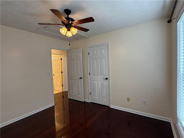 1245 Mulberry Mill Ln, Lawrenceville, GA 30043 - unfurnished bedroom featuring dark wood finished floors, attic access, a ceiling fan, and a textured ceiling