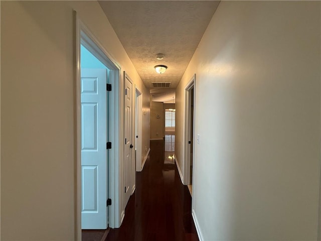 1245 Mulberry Mill Ln, Lawrenceville, GA 30043 - hall featuring a textured ceiling and dark wood finished floors