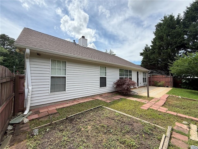 1245 Mulberry Mill Ln, Lawrenceville, GA 30043 - rear view of house with a patio area, a chimney, and roof with shingles
