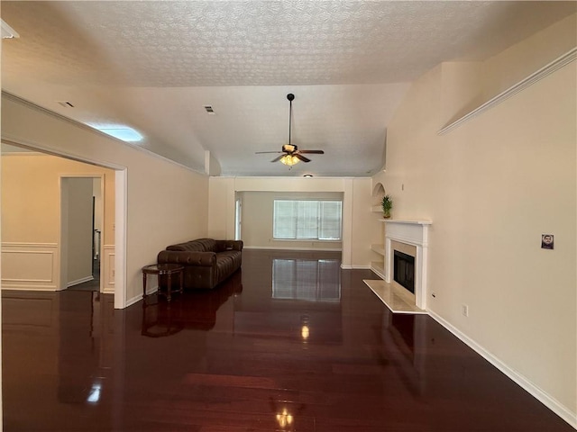 1245 Mulberry Mill Ln, Lawrenceville, GA 30043 - living area with a ceiling fan, wood finished floors, a premium fireplace, vaulted ceiling, and a textured ceiling