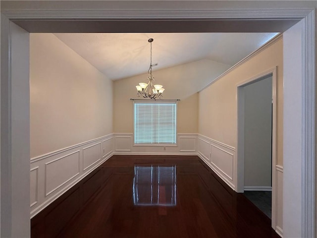 1245 Mulberry Mill Ln, Lawrenceville, GA 30043 - unfurnished dining area with lofted ceiling, a chandelier, dark wood-type flooring, a decorative wall, and wainscoting