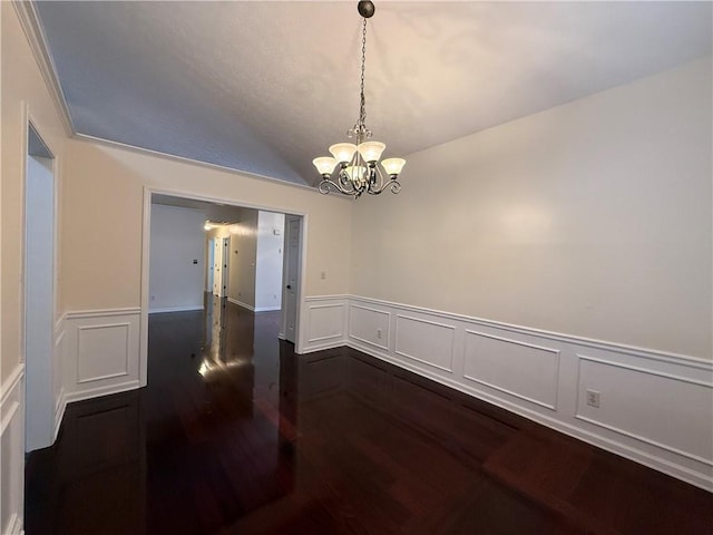 1245 Mulberry Mill Ln, Lawrenceville, GA 30043 - spare room featuring a chandelier, dark wood-style floors, a decorative wall, wainscoting, and vaulted ceiling