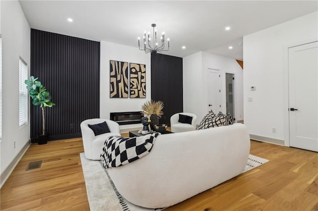 1129 Victory Dr SW, Atlanta, GA 30310 - living area with recessed lighting, a chandelier, light wood finished floors, a glass covered fireplace, and baseboards