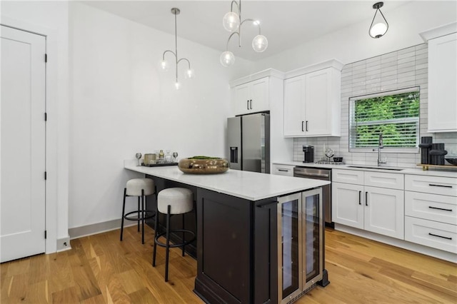 1129 Victory Dr SW, Atlanta, GA 30310 - kitchen with stainless steel refrigerator with ice dispenser, a sink, wine cooler, and white cabinets