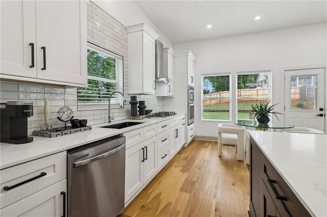 1129 Victory Dr SW, Atlanta, GA 30310 - kitchen featuring appliances with stainless steel finishes, a sink, white cabinetry, light wood-style flooring, and light stone countertops