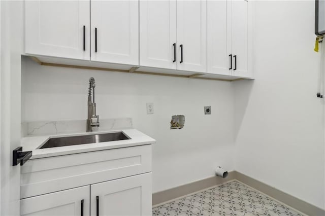 1129 Victory Dr SW, Atlanta, GA 30310 - washroom with hookup for an electric dryer, baseboards, cabinet space, and light floors