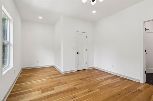 1129 Victory Dr SW, Atlanta, GA 30310 - unfurnished bedroom with multiple windows, light wood-type flooring, recessed lighting, and baseboards