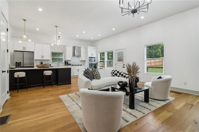 1129 Victory Dr SW, Atlanta, GA 30310 - living room with a chandelier, light wood-style flooring, and recessed lighting
