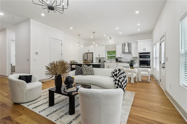 1129 Victory Dr SW, Atlanta, GA 30310 - living room with light wood-type flooring, a chandelier, recessed lighting, and baseboards