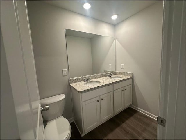 75 Emerald Ln, Covington, GA 30014 - full bath featuring toilet, double vanity, wood finished floors, baseboards, and recessed lighting