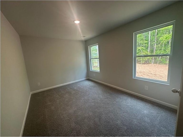 75 Emerald Ln, Covington, GA 30014 - empty room featuring baseboards, dark carpet, and recessed lighting