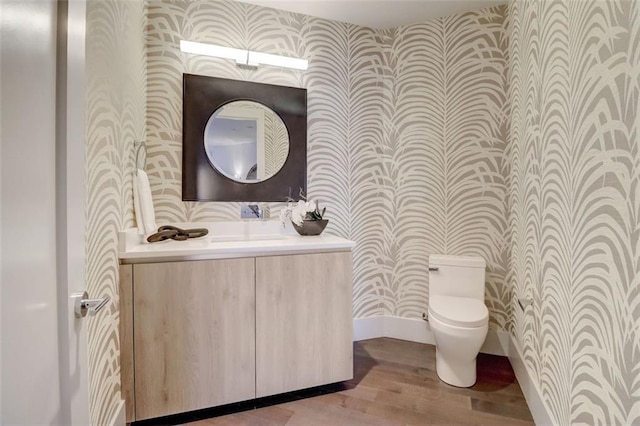 bathroom featuring hardwood / wood-style floors, vanity, and toilet