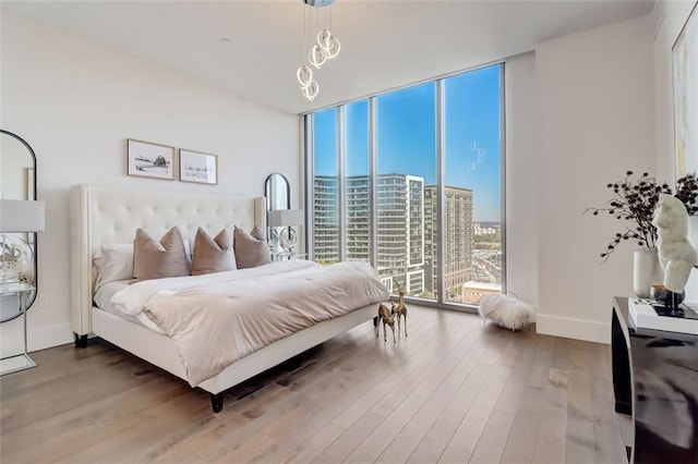 bedroom featuring access to outside and hardwood / wood-style flooring