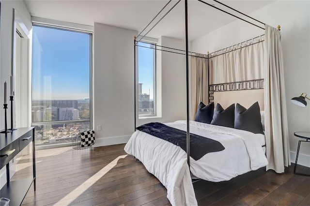 bedroom with dark hardwood / wood-style flooring