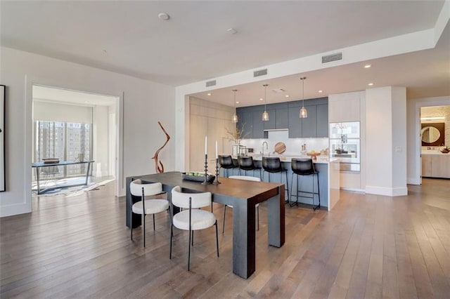 dining area with hardwood / wood-style flooring and sink