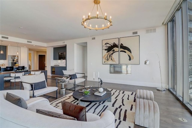 living room with an inviting chandelier and wood-type flooring