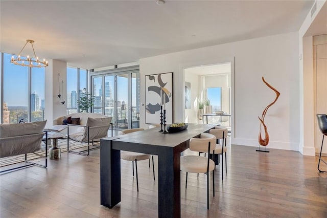 dining area featuring hardwood / wood-style flooring and a notable chandelier