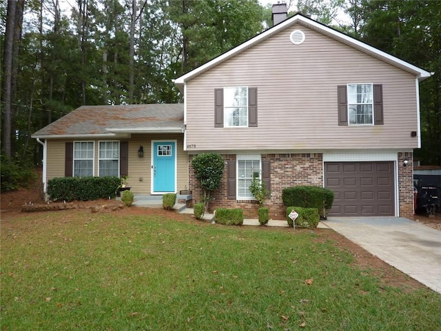 tri-level home featuring a garage, brick siding, driveway, a front lawn, and a chimney