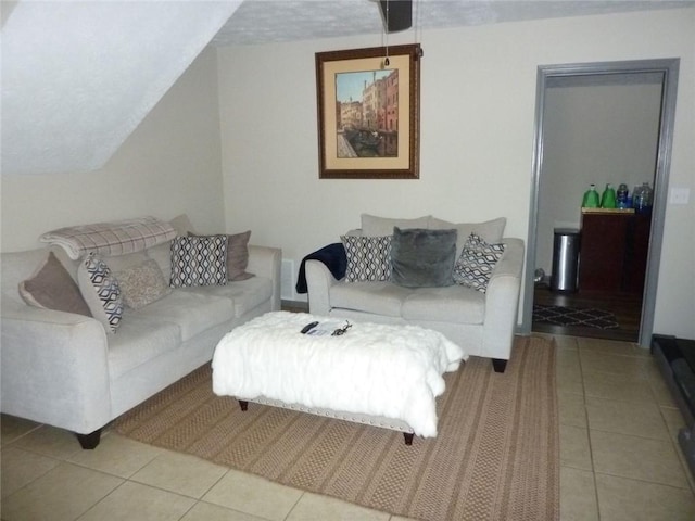 tiled living area with lofted ceiling