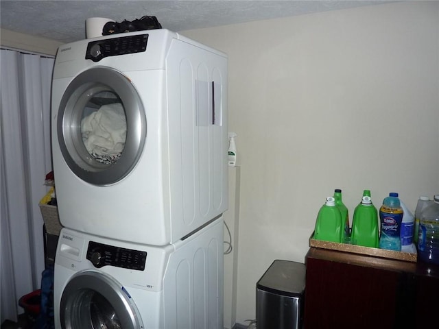 laundry area with stacked washer and dryer and laundry area