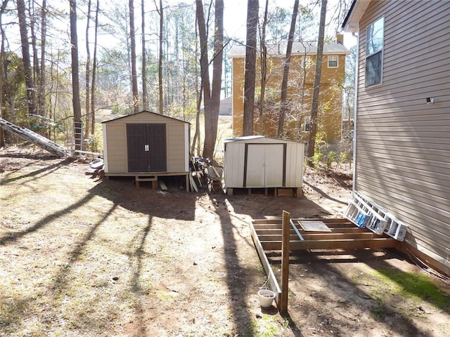 view of yard with a storage unit and an outbuilding