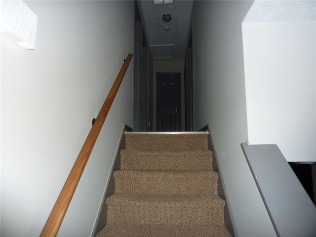 staircase featuring baseboards