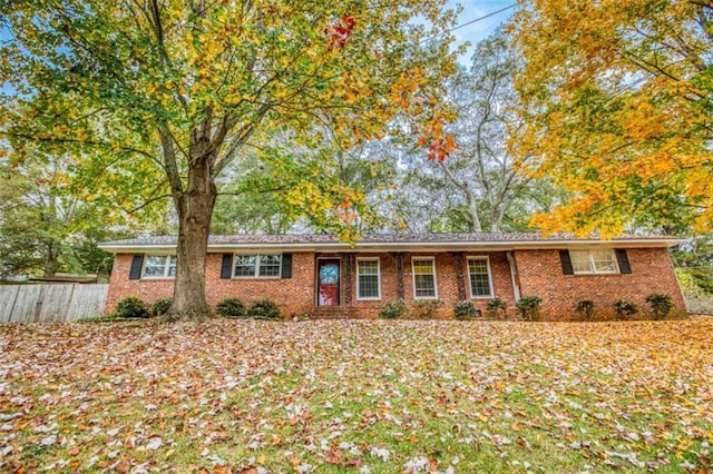 ranch-style house with brick siding and fence