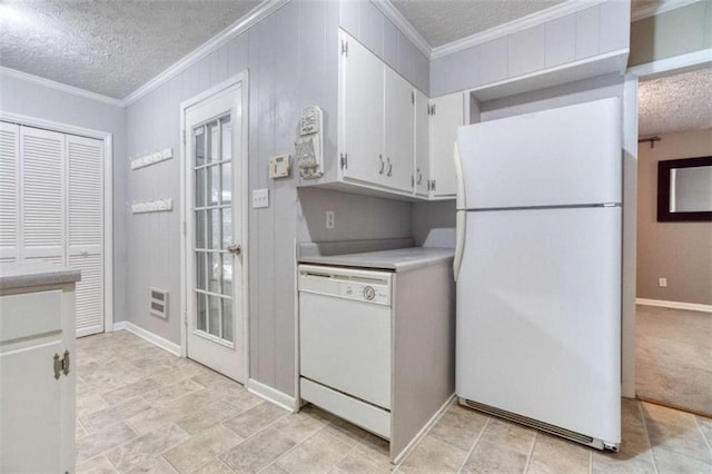 kitchen with a textured ceiling, white appliances, white cabinets, and crown molding