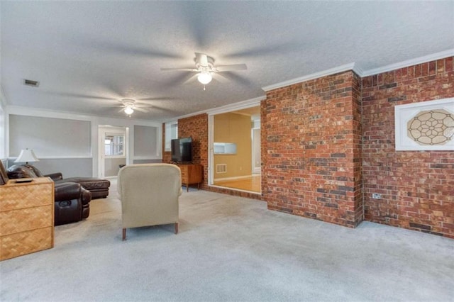 carpeted living room with brick wall, crown molding, visible vents, and a textured ceiling