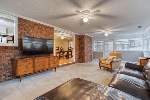 living area featuring ornamental molding, carpet flooring, visible vents, and a textured ceiling