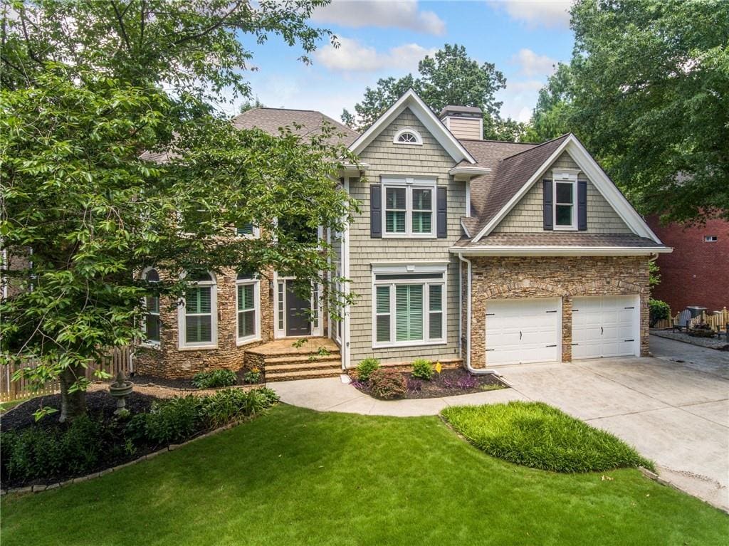 craftsman house with a garage and a front yard