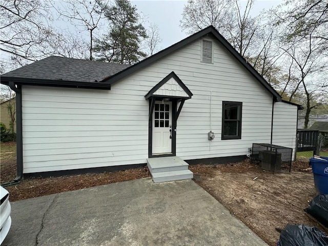 bungalow with roof with shingles and central AC