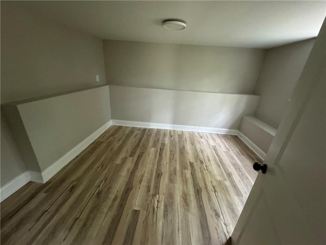 empty room with wood finished floors and baseboards