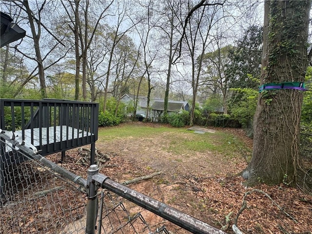view of yard featuring a deck and fence
