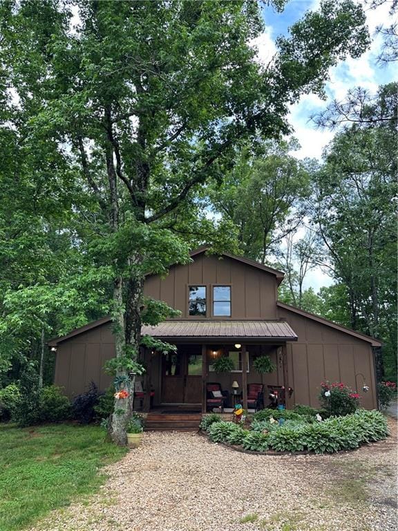 view of front of house featuring a storage unit and covered porch