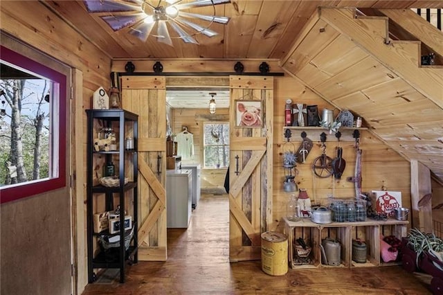 interior space featuring wood walls, hardwood / wood-style flooring, wood ceiling, and lofted ceiling