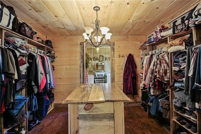 spacious closet with a chandelier and wood-type flooring