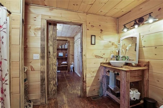 bathroom featuring wood walls, vanity, hardwood / wood-style flooring, and wood ceiling